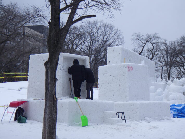 西9丁目雪まつり会場市民の広場にて雪像制作に取り組む市民の画像